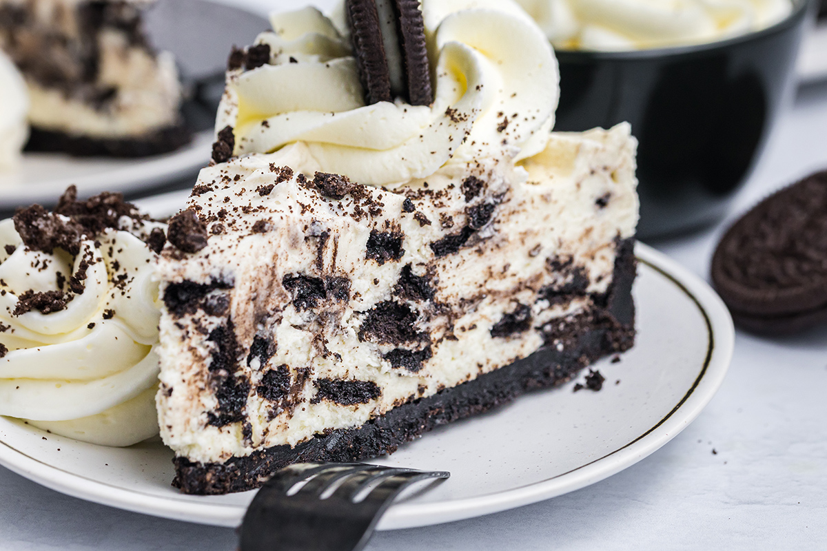 close up straight on shot of slice of oreo cheesecake on plate
