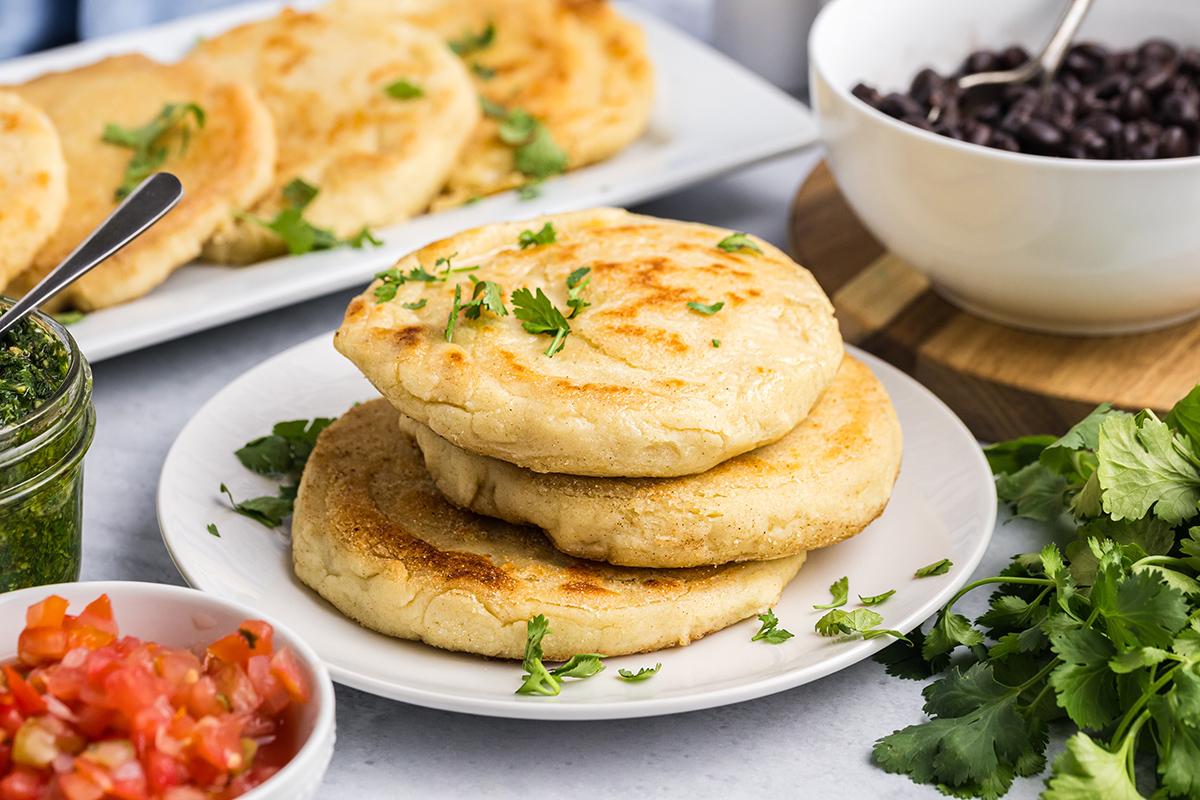 angled shot of stack of three arepas con queso