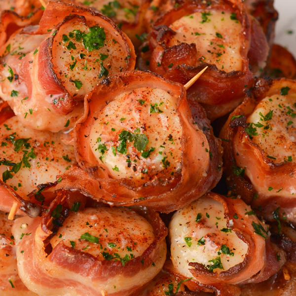 close up overhead shot of plate of scallops wrapped in bacon