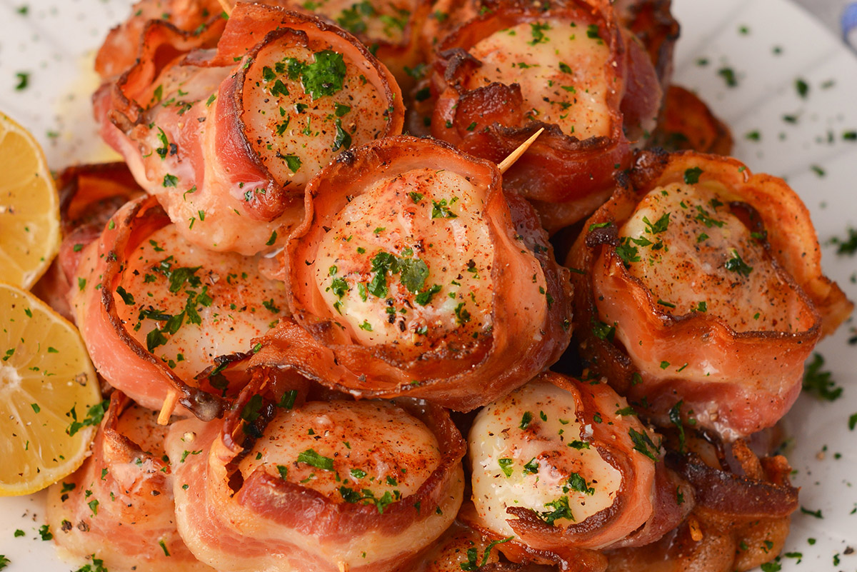 close up overhead shot of plate of scallops wrapped in bacon