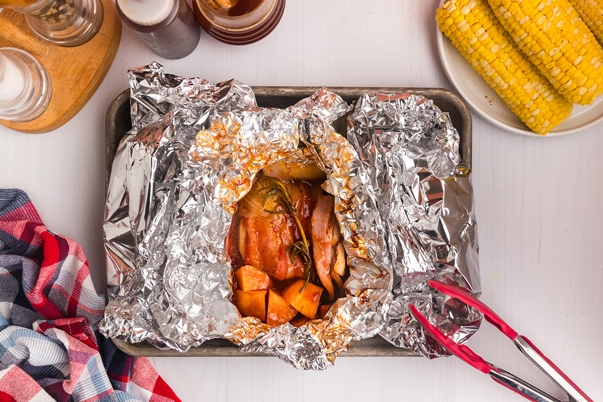 overhead shot of chicken foil packets opening