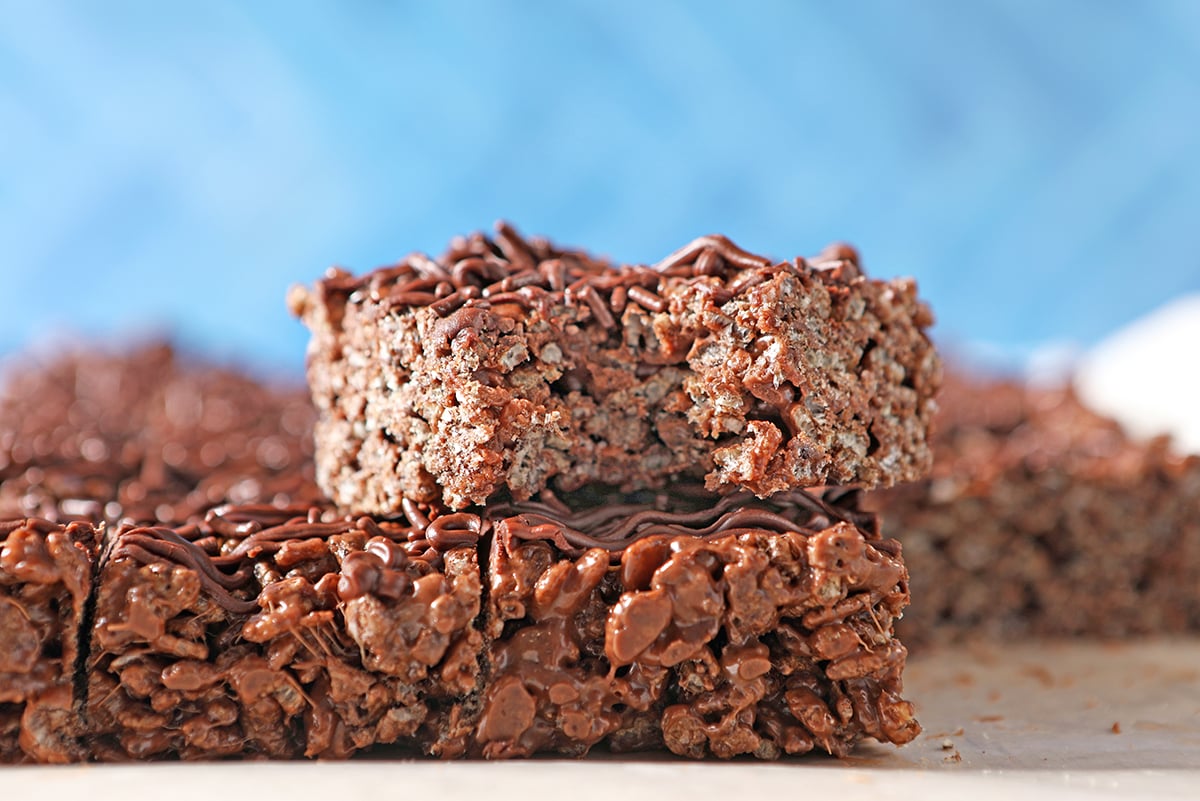 head on shot of a chocolate rice krispie treat with a bite taken out of it