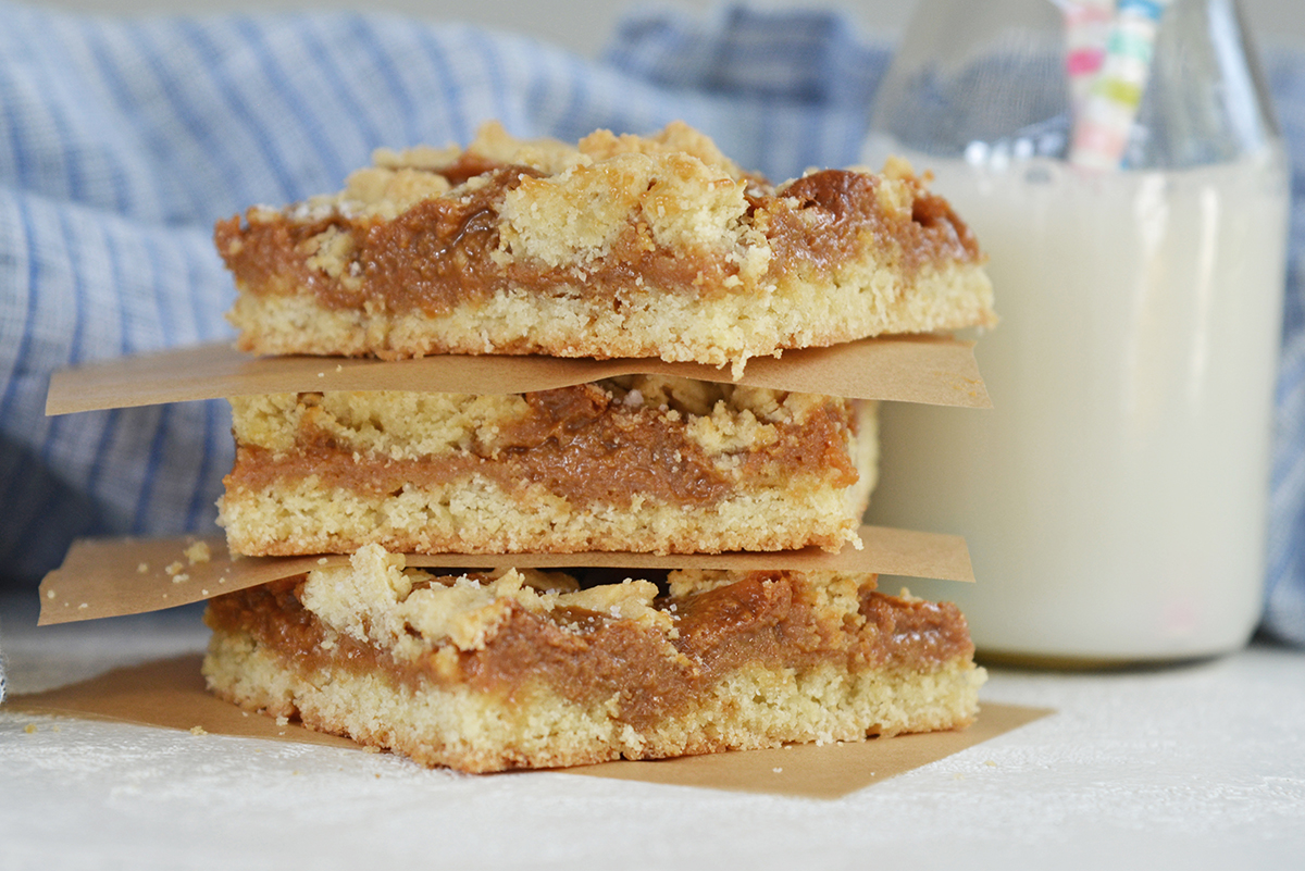 layered dulce de leche cookie bars with milk