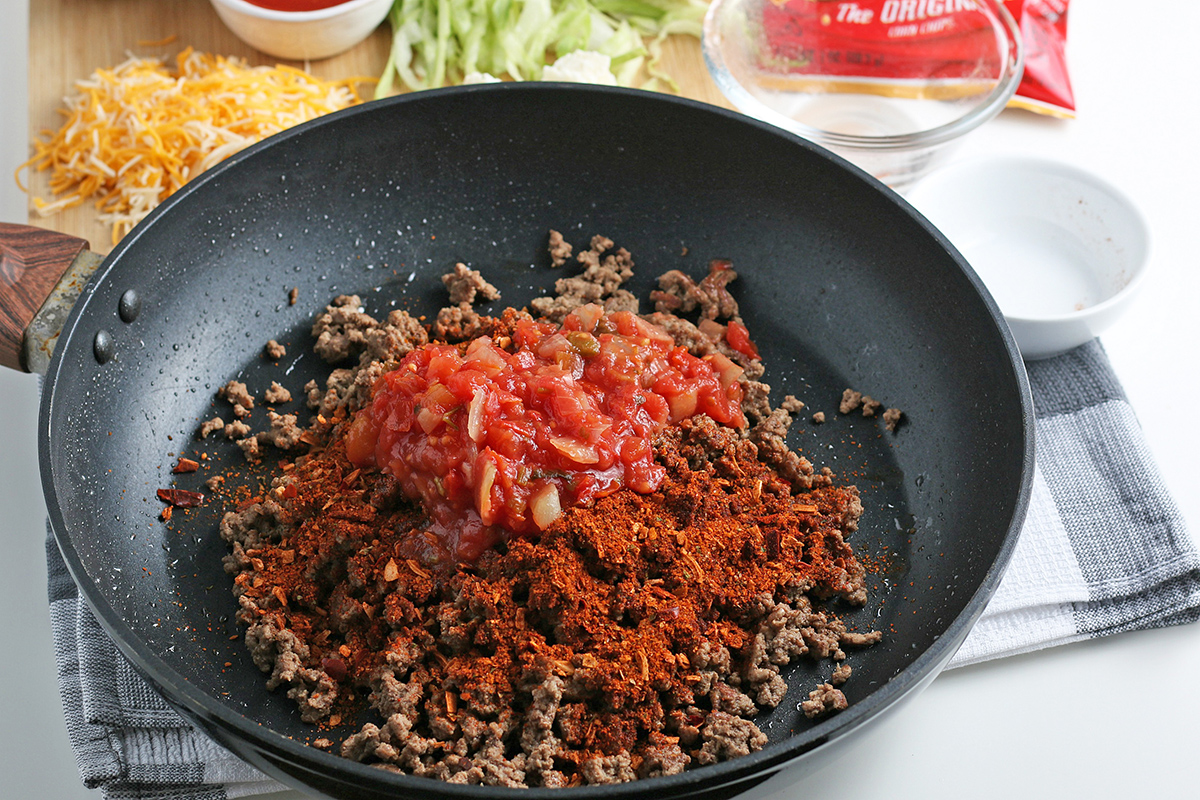 salsa and taco seasoning in pan of ground beef