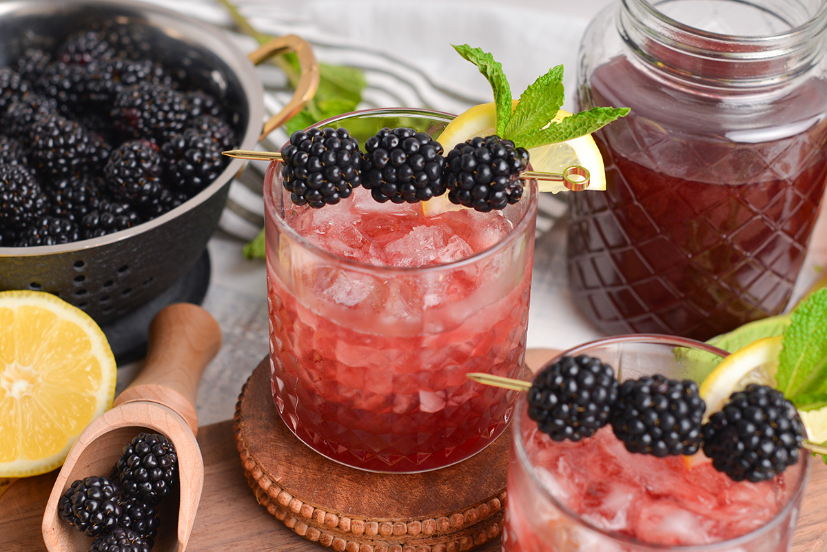 angled shot of two blackberry bourbon cocktails