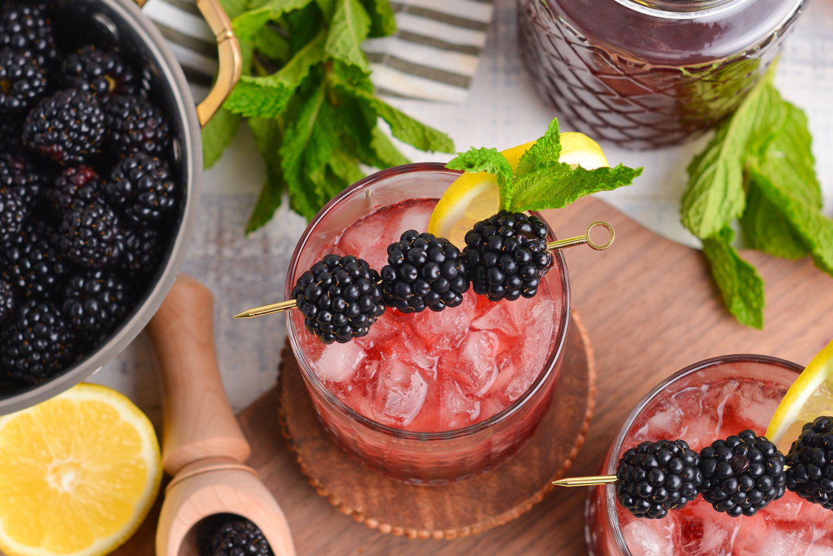 close up overhead shot of blackberry bourbon smash in glass