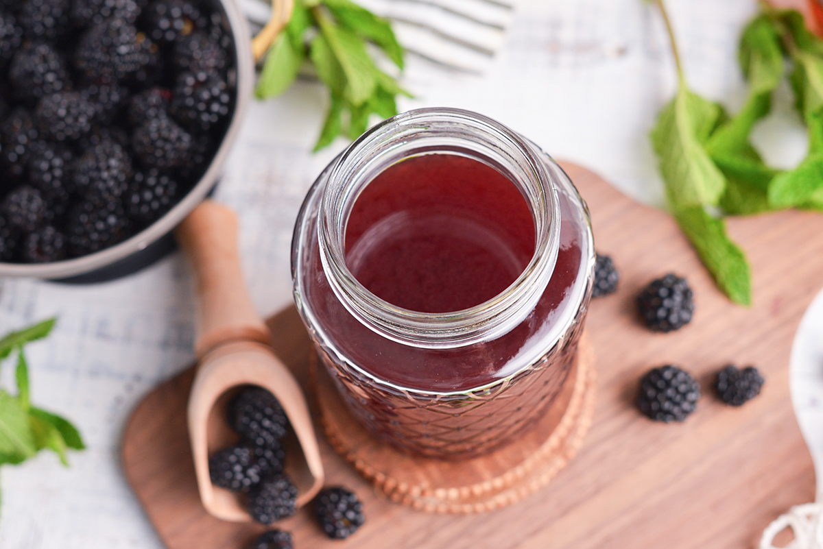 angled overhead shot of homemade blackberry brandy in jar