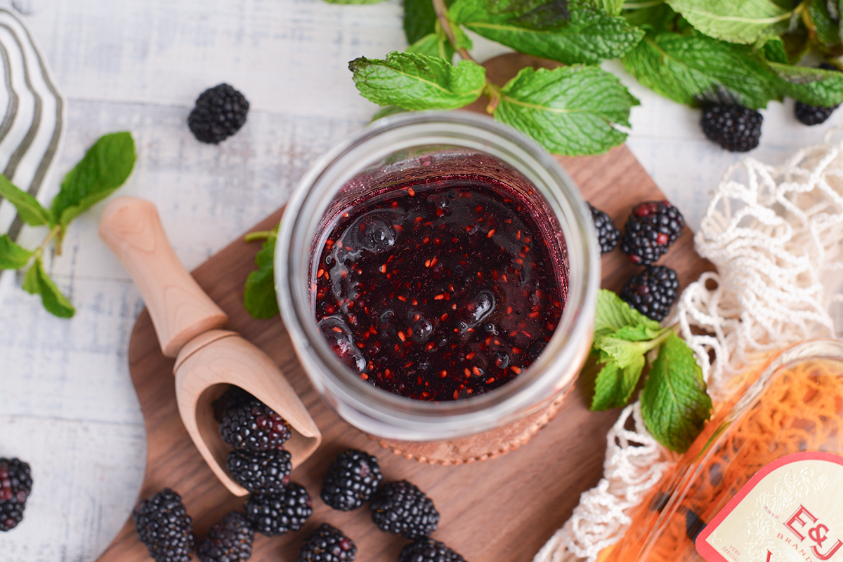 overhead shot of blackberries muddled in jar