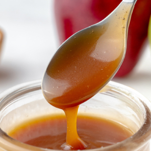 caramel sauce dripping off of spoon