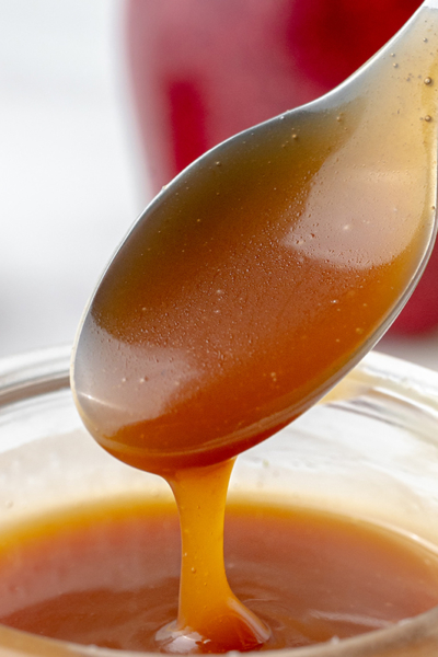 caramel sauce dripping off of spoon