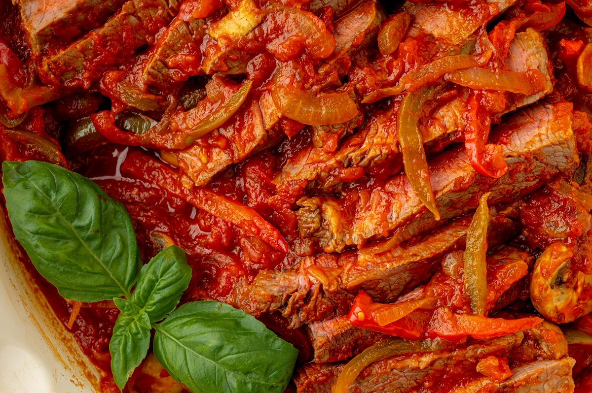 close up overhead shot of carne alla pizzaiola in pan