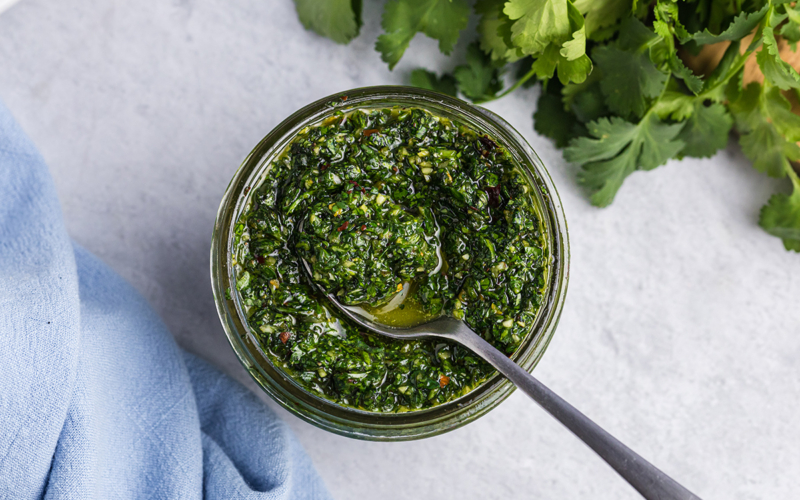 overhead of small spoon in homemade chimichurri sauce