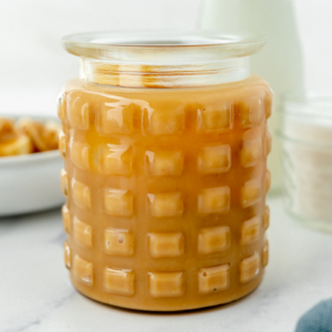 angled shot of jar of sweetened condensed milk caramel