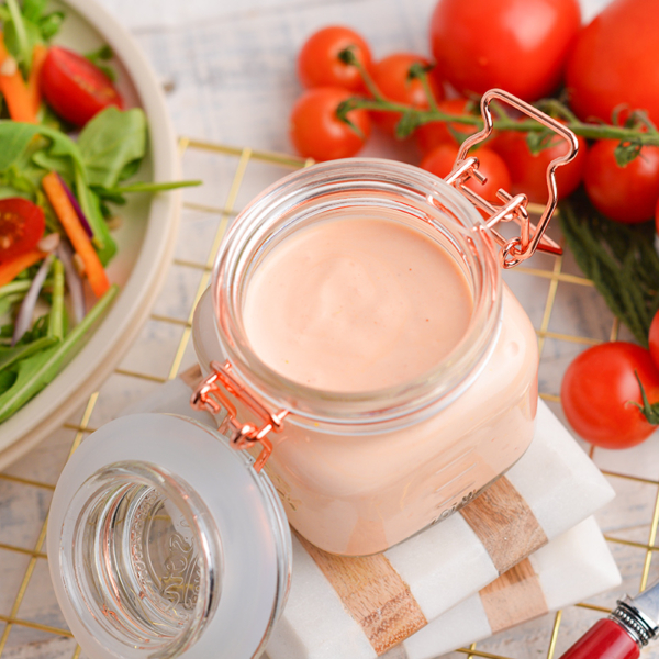 angled shot of creamy dressing in jar