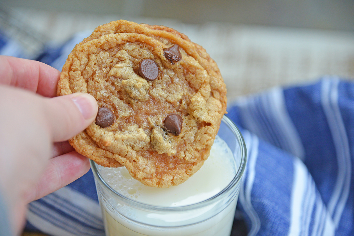 flourless peanut butter cookie dipping into a glass of milk