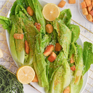 overhead of romaine stalks with parmesan cheese, garlic dressing and croutons