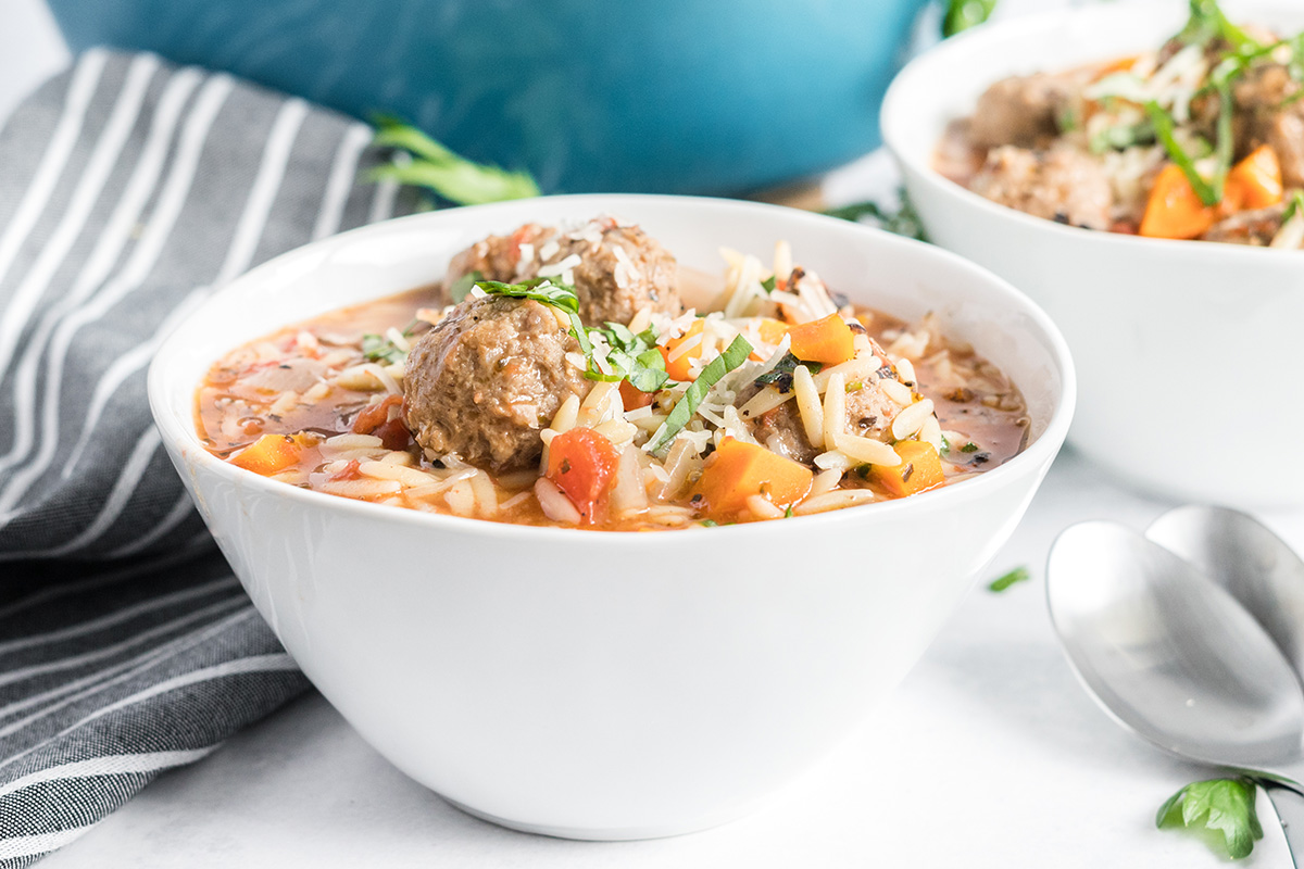 side view of meatballs in a soup bowl