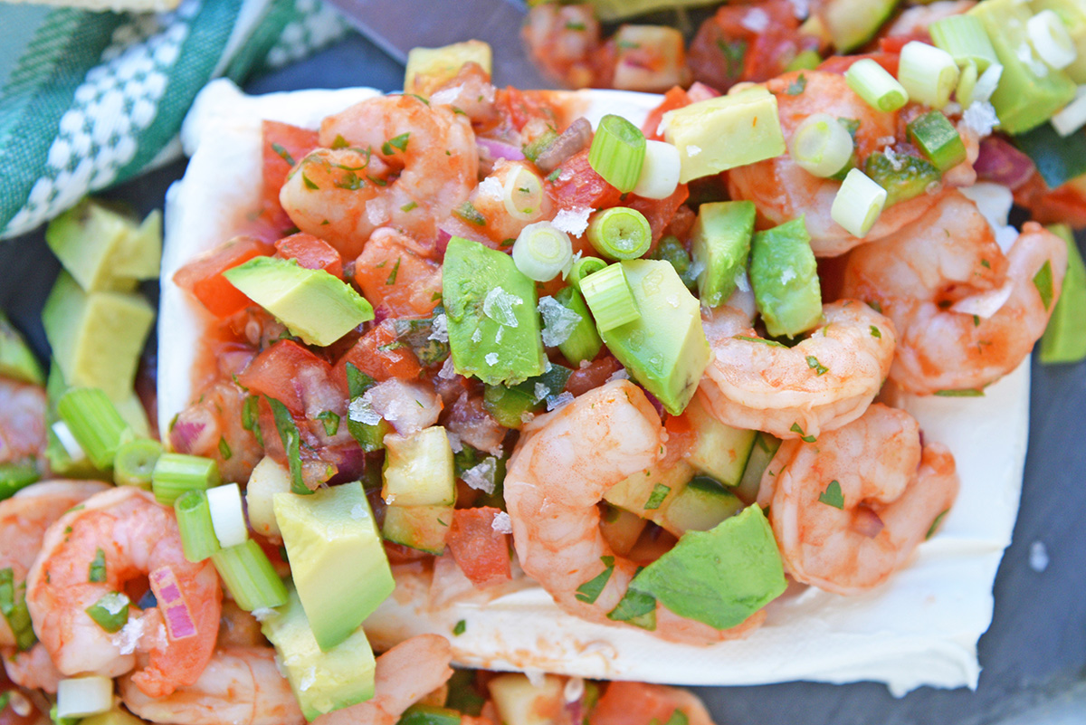 Close up of Mexican shrimp dip with avocado, shrimp, tomatoes and more!