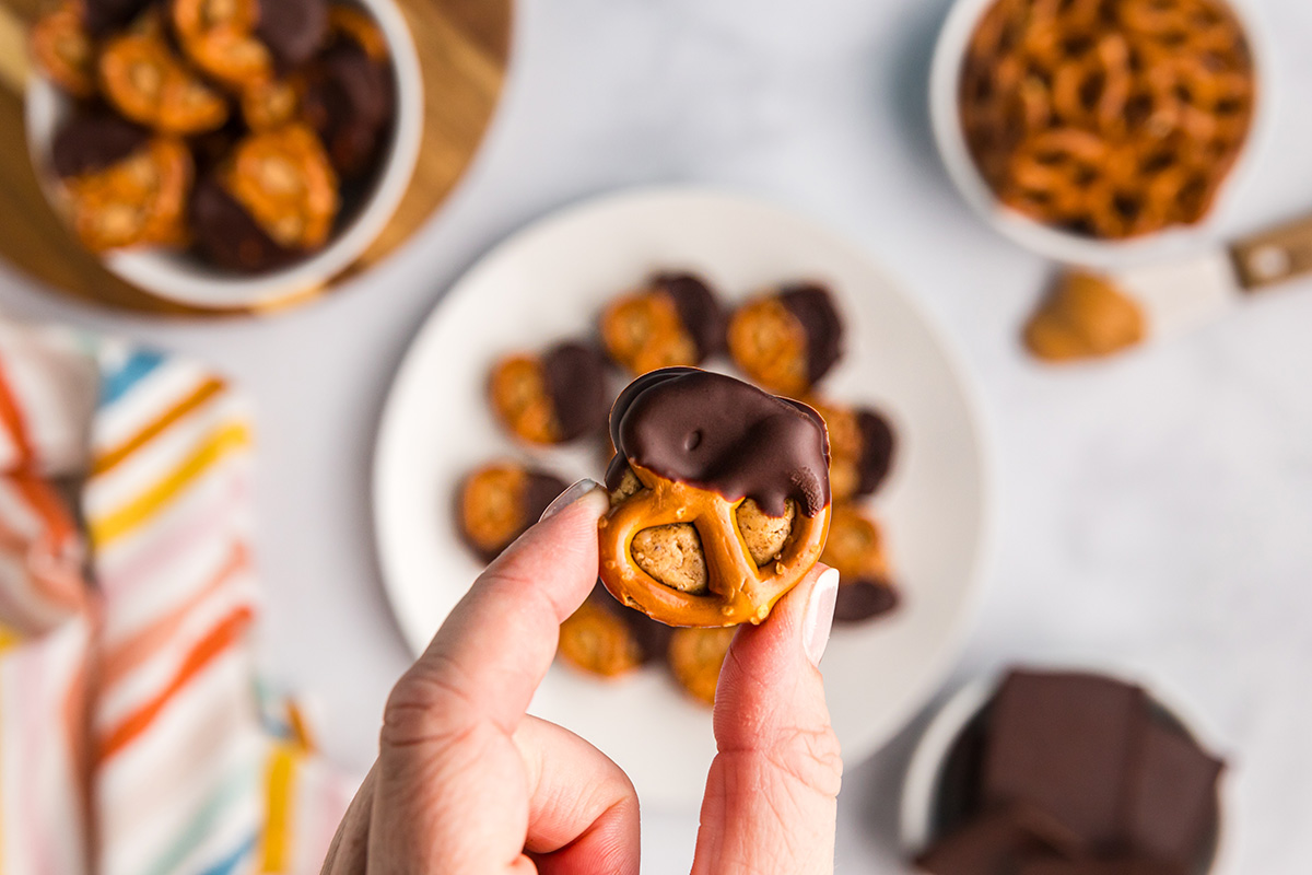 overhead shot of hand holding peanut butter pretzel bite