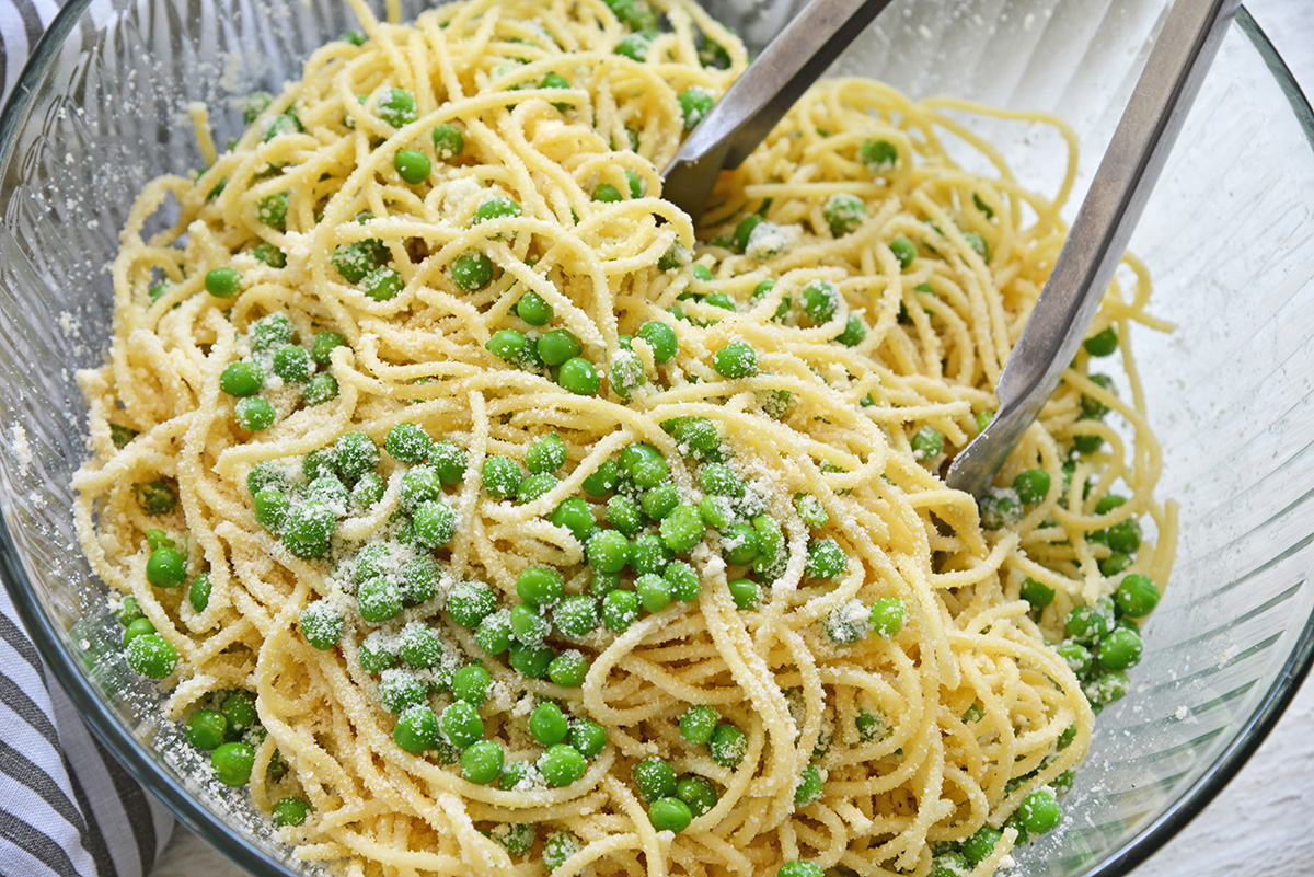 pasta and peas in a mixing bowl