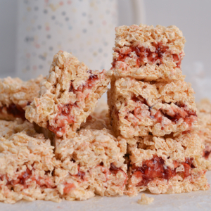 peanut butter and jelly rice krispie treats stacked in a pile
