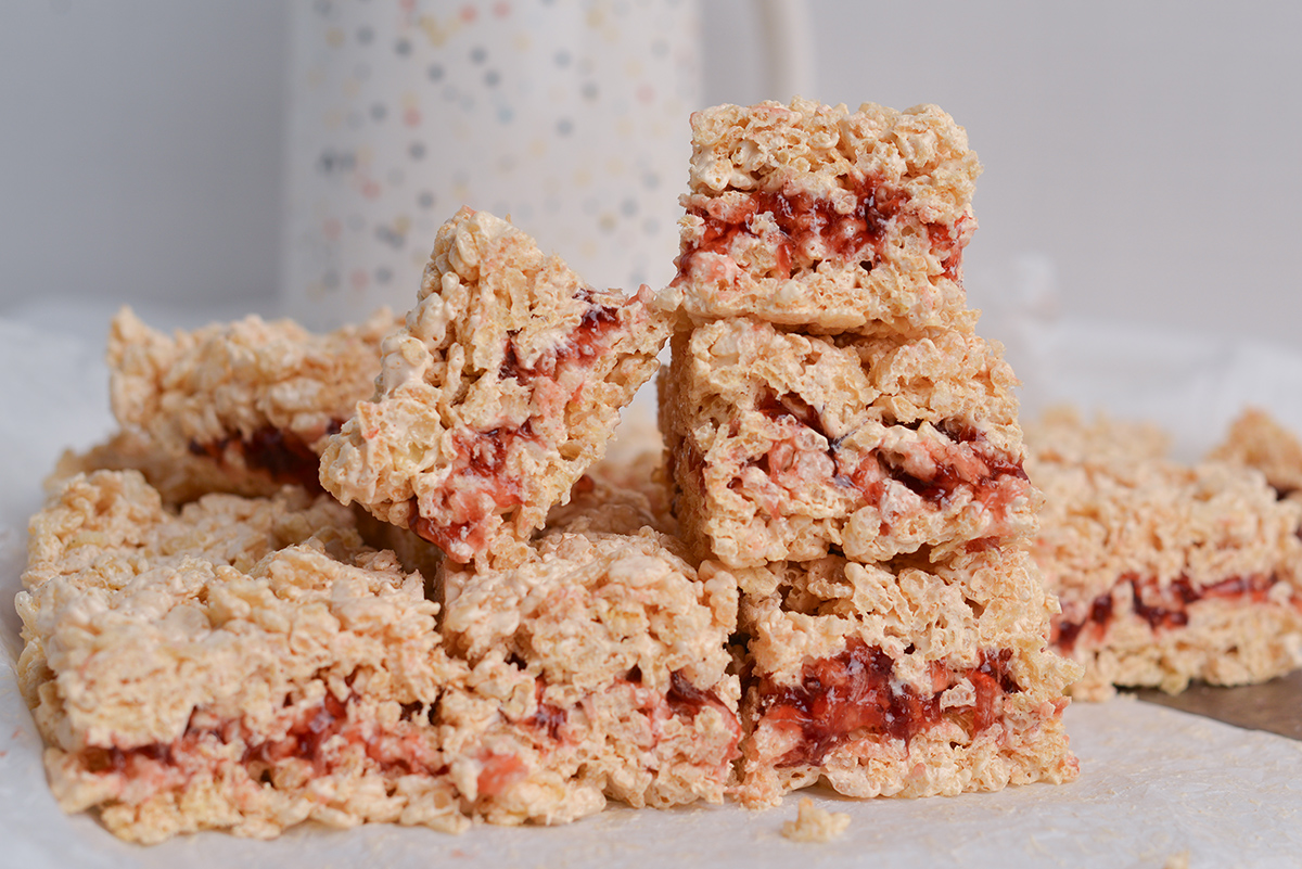 peanut butter and jelly rice krispie treats stacked in a pile