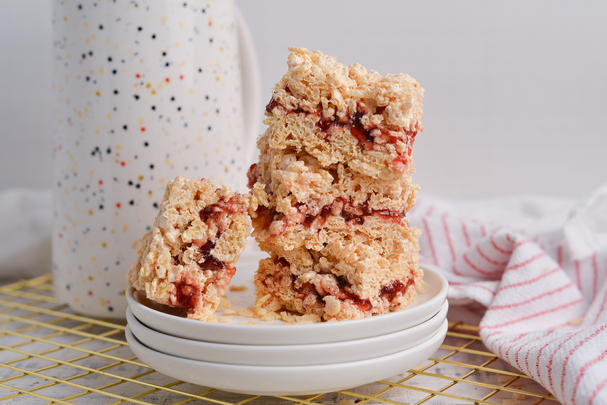 stack of peanut butter and jelly rice krispie treats on a stack of plates