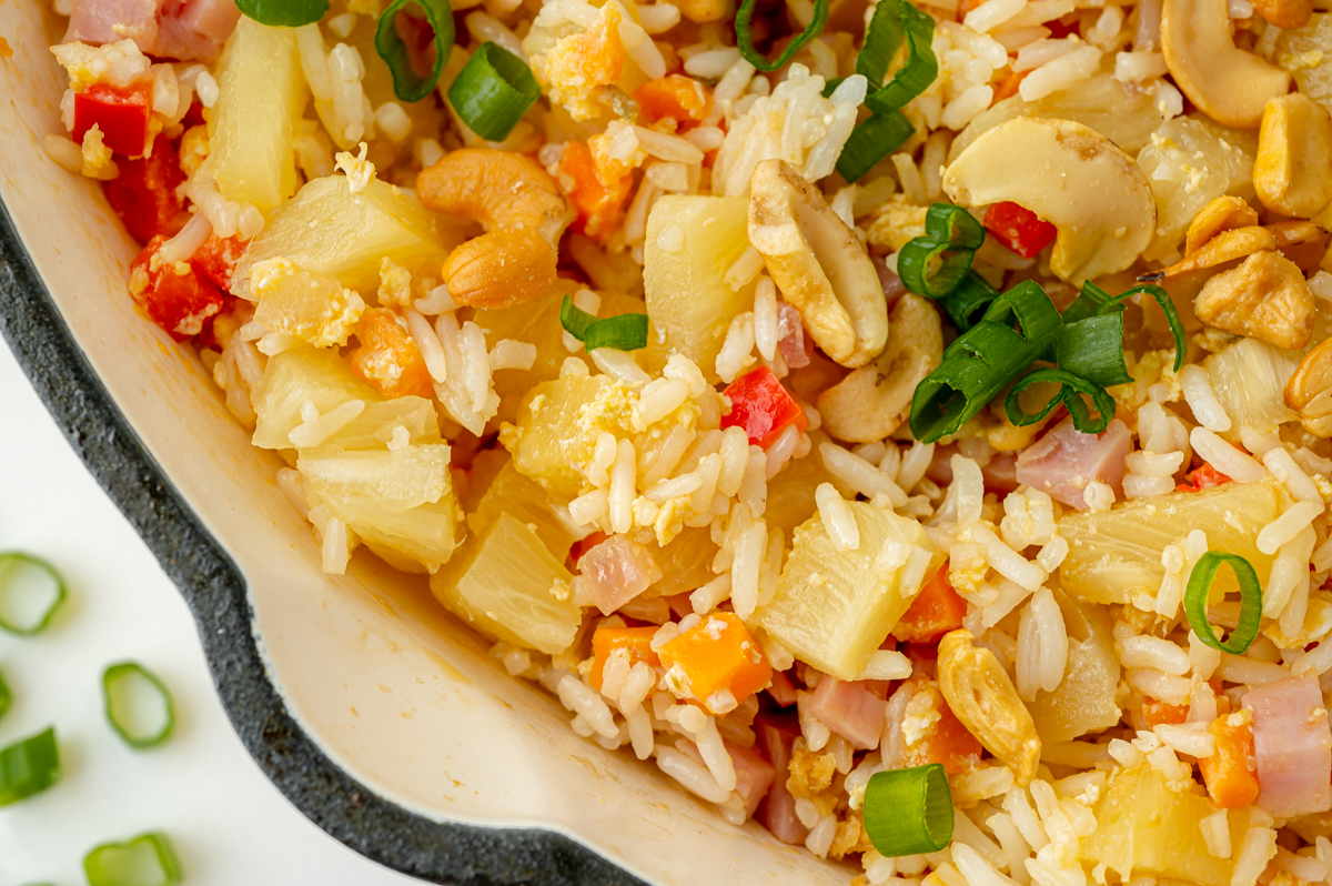 close up of fried rice with pineapple in a skillet