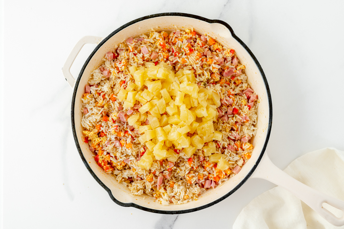 pineapple fried rice ingredients in a pan