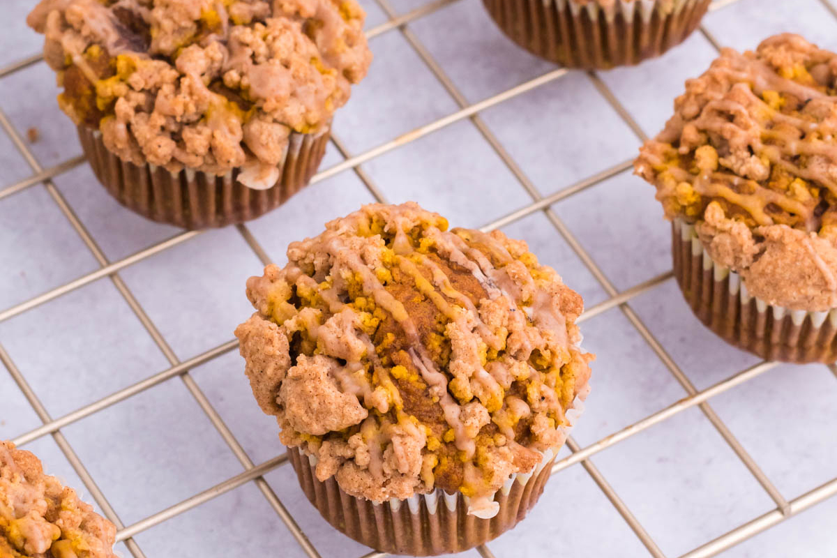 angled shot of pumpkin muffins on cooling rack