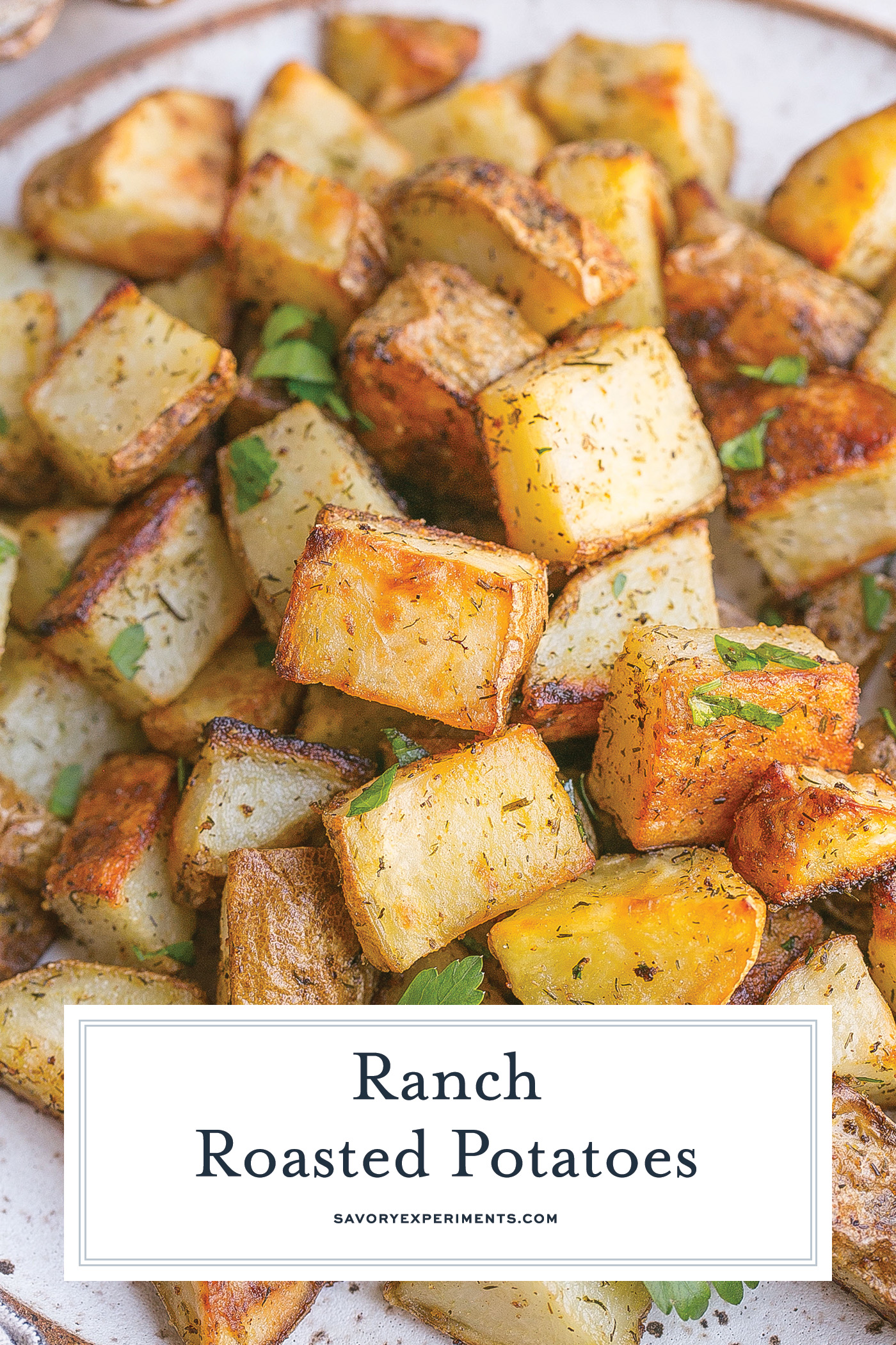 angled shot of roasted ranch potatoes on plate with text overlay