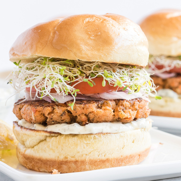 close up shot of salmon burger on plate