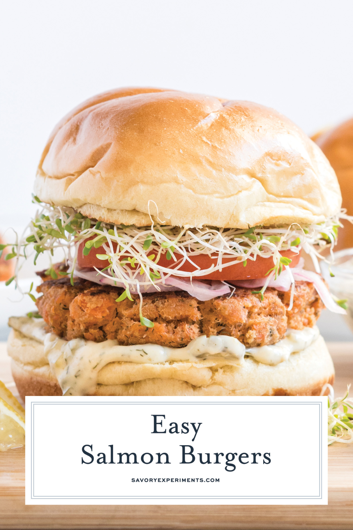 straight on shot of salmon burger with text overlay for pinterest