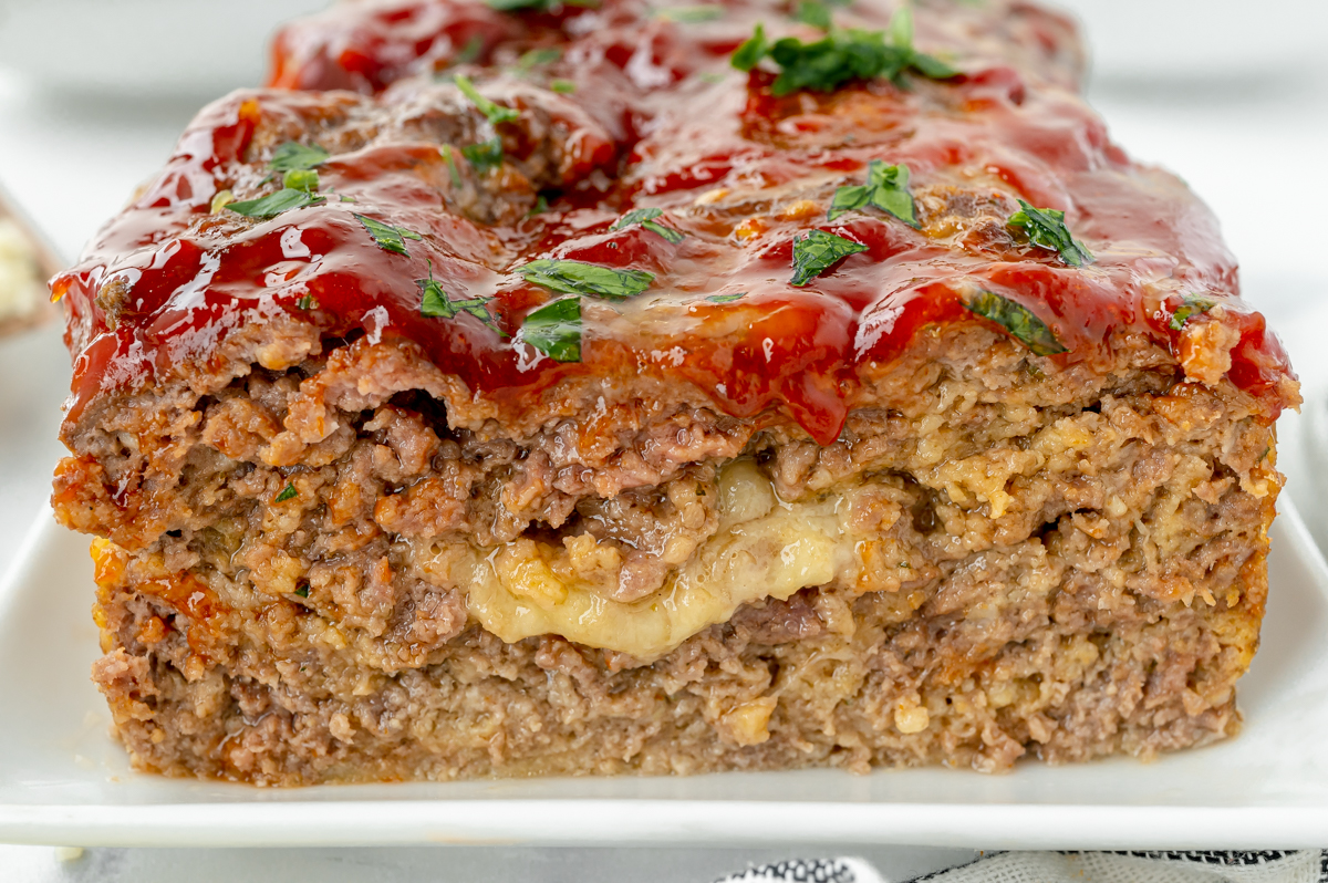 close up straight on shot of stuffed meatloaf on platter