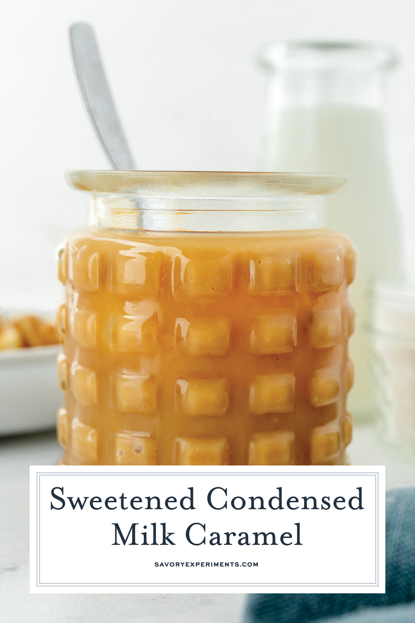 straight on shot of spoon in jar of sweetened condensed milk caramel with text overlay