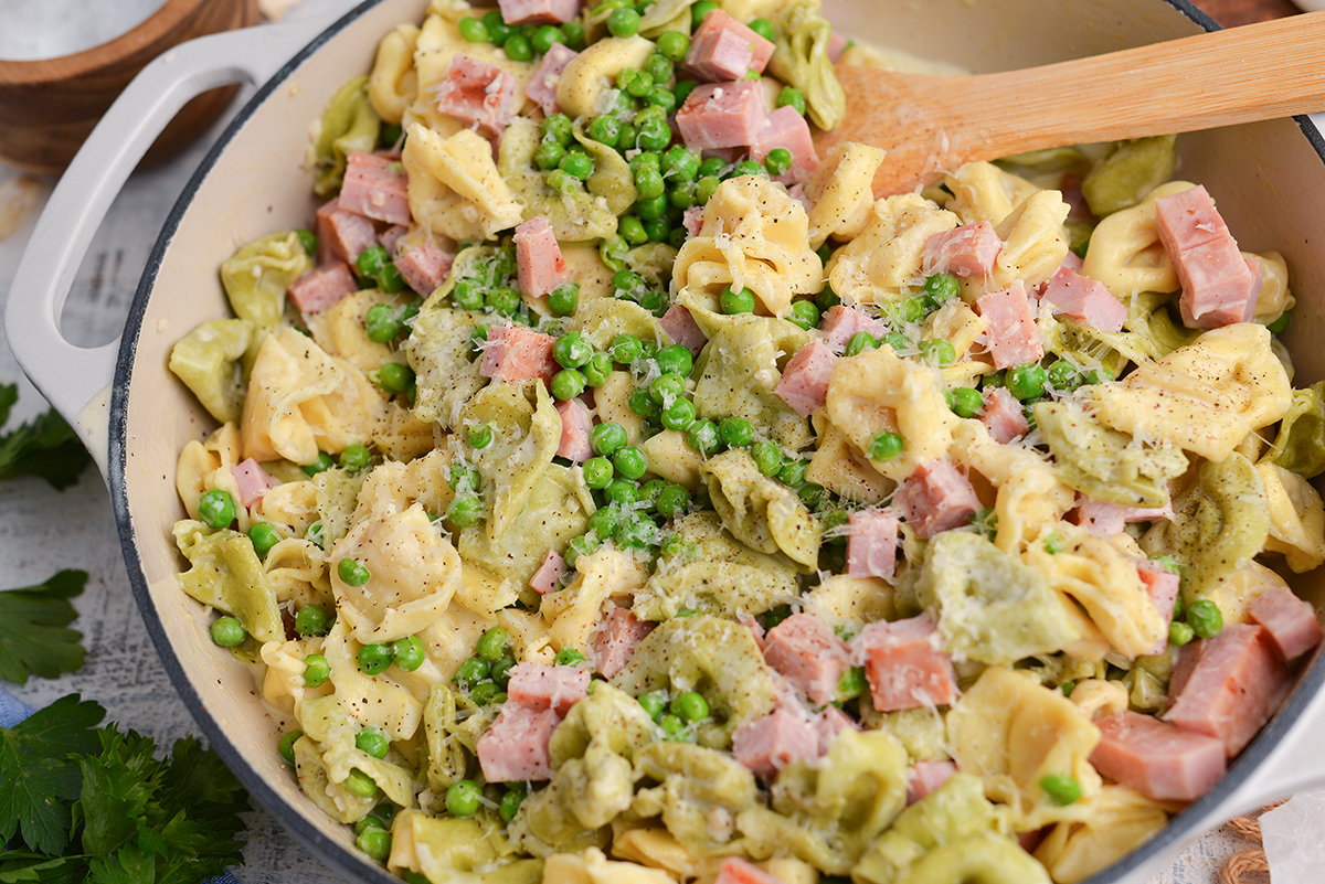 close up angled shot of ham and cheese tortellini in pan
