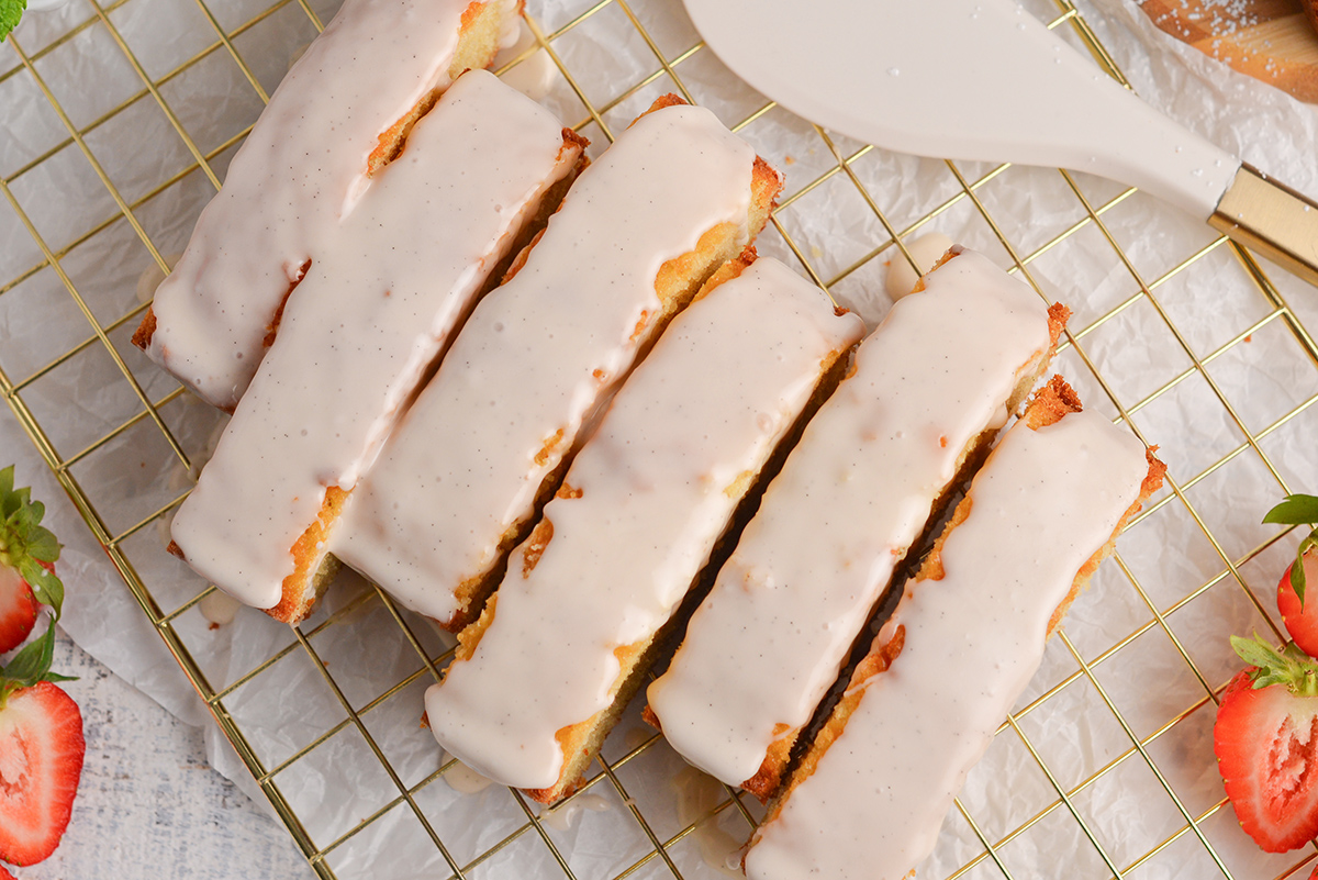 close up overhead shot of sliced vanilla pound cake topped with glaze