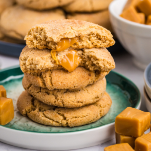 stack of caramel apple cookies on apple with caramels