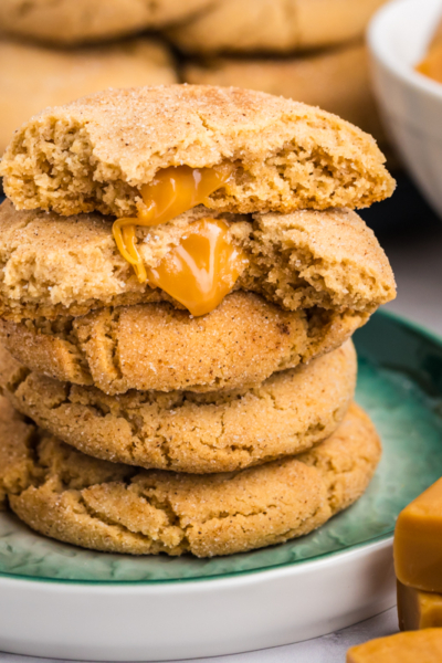 stack of caramel apple cookies on apple with caramels