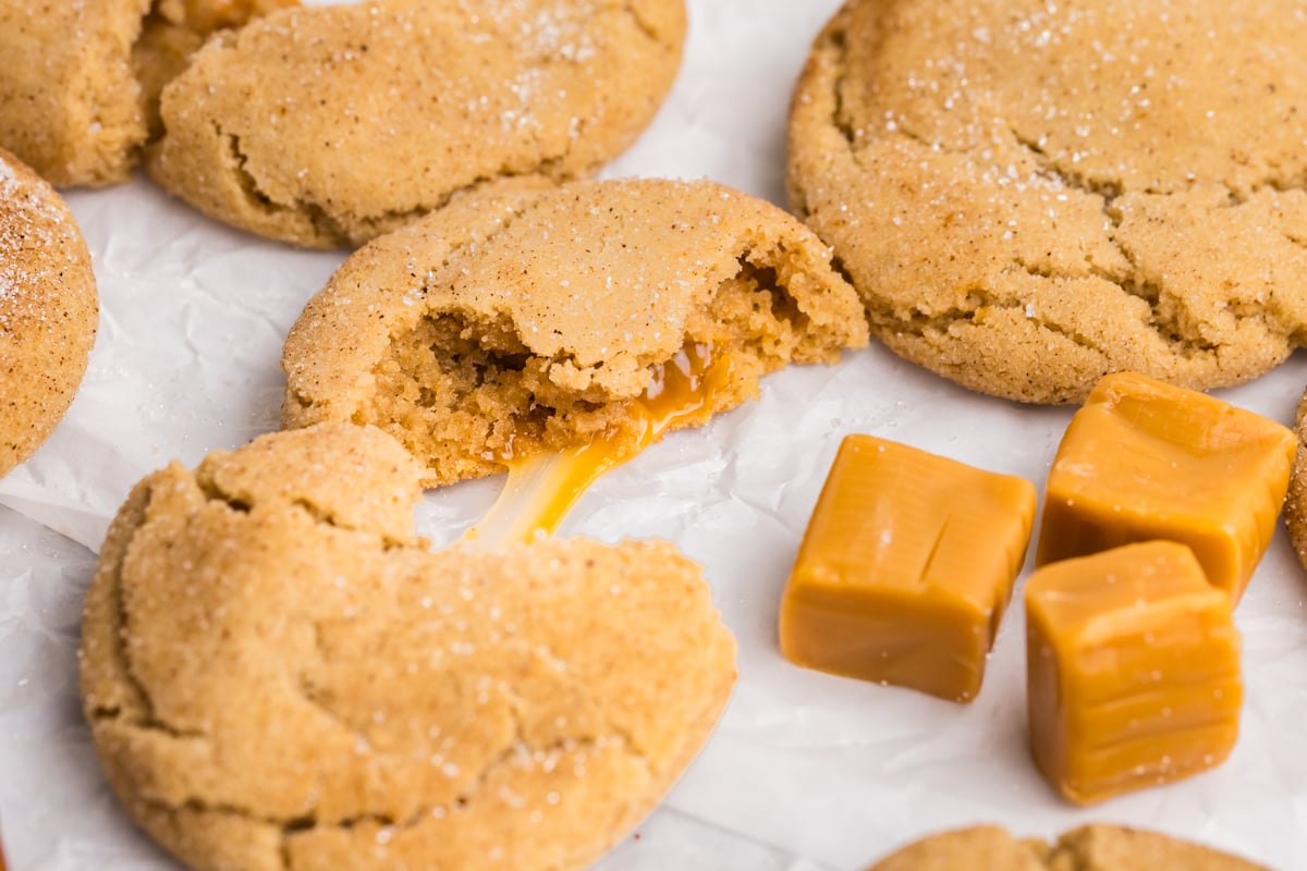 close up angled shot of caramel apple cookie broken in half