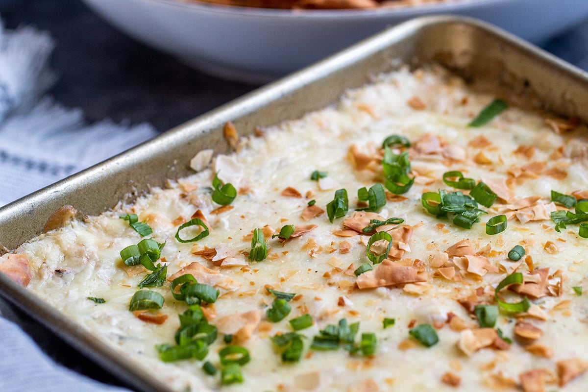 close up of crab dip with green onions