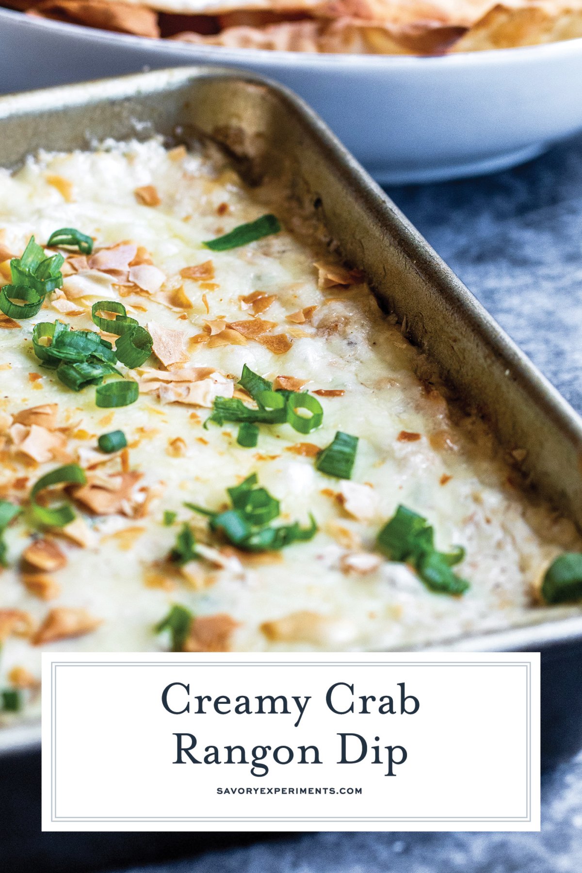 angle of cheesy crab dip with text overlay for pinterest