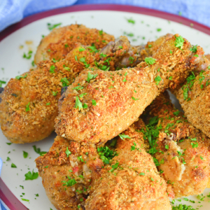 serving platter of oven fried chicken with parsley garnish