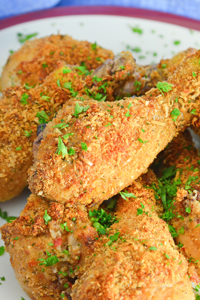 serving platter of oven fried chicken with parsley garnish