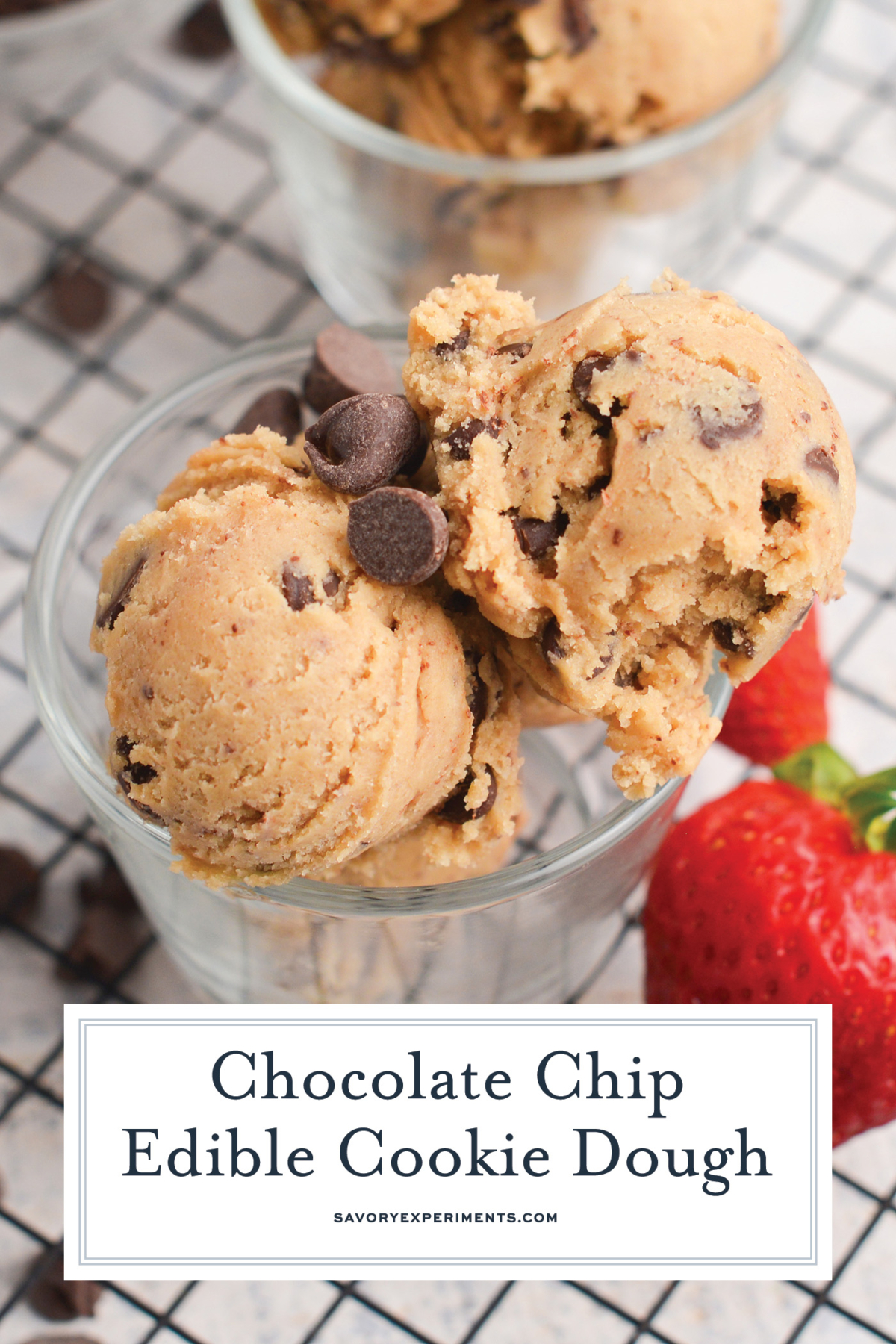 overhead close up of two scoops of edible cookie dough with a strawberry next to it