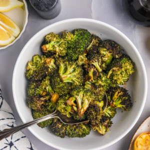 overhead shot of spoon in bowl of grilled broccoli