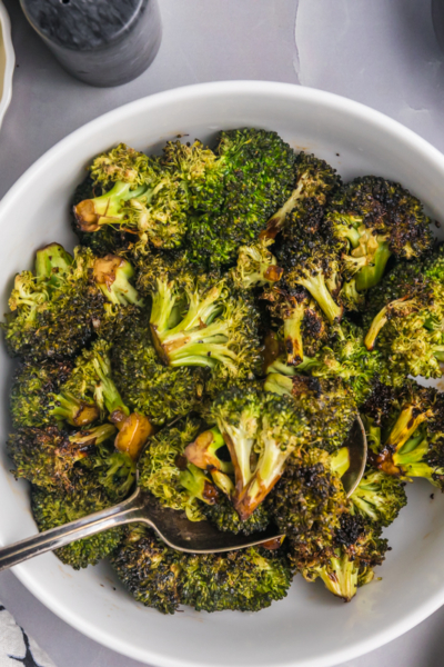 overhead shot of spoon in bowl of grilled broccoli