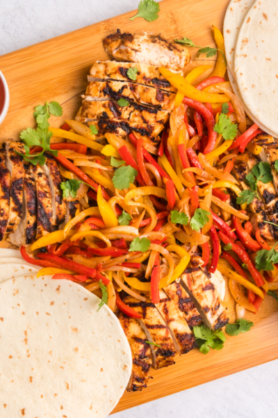 overhead shot of board of grilled chicken fajitas