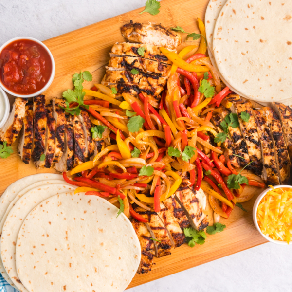 overhead shot of board of grilled chicken fajitas