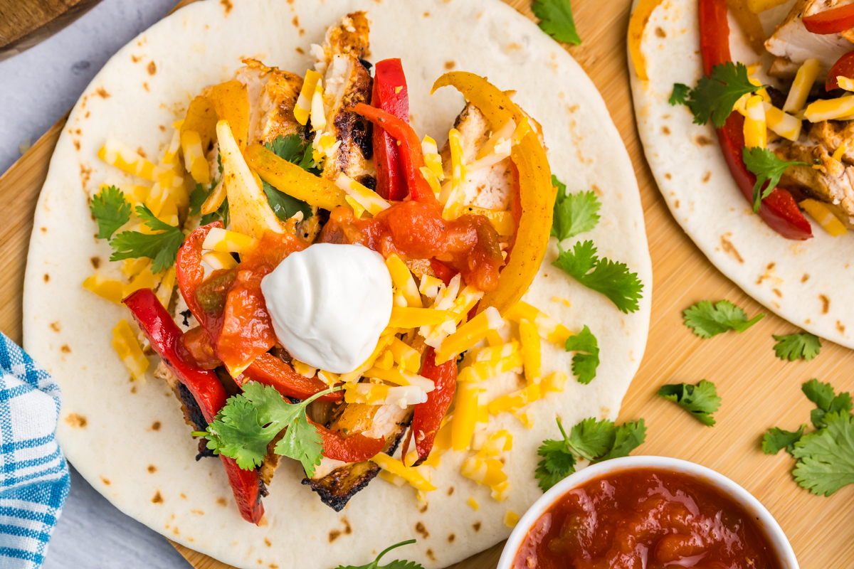 close up overhead shot of grilled chicken fajita on board